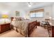 Bedroom featuring neutral walls, ceiling fan, and wood rocking chair at 2500 Cedar Cove Dr, Harrisburg, NC 28075
