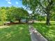 Charming blue home with a welcoming front porch and rocking chairs, set on a spacious lawn at 2500 Cedar Cove Dr, Harrisburg, NC 28075