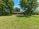 Charming blue home with a welcoming front porch and rocking chairs, set on a spacious lawn at 2500 Cedar Cove Dr, Harrisburg, NC 28075
