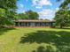 Charming blue home with a welcoming front porch and rocking chairs, set on a spacious lawn at 2500 Cedar Cove Dr, Harrisburg, NC 28075