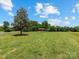 Lush front lawn leading to a charming home with inviting porch, set against a beautiful blue sky at 2500 Cedar Cove Dr, Harrisburg, NC 28075
