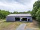 Spacious metal garage with multiple bays, perfect for storage or a workshop on this property at 2500 Cedar Cove Dr, Harrisburg, NC 28075