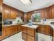 The kitchen features stained wood cabinets, ample counter space, and modern appliances at 2500 Cedar Cove Dr, Harrisburg, NC 28075