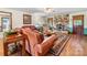 Inviting living room with a stone fireplace, leather couches, and a patterned rug at 2500 Cedar Cove Dr, Harrisburg, NC 28075