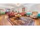 Spacious living room features hardwood floors, ceiling fans, and a beautiful area rug at 2500 Cedar Cove Dr, Harrisburg, NC 28075