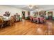 Open living space showcasing hardwood floors, a stone fireplace, and comfortable seating arrangements at 2500 Cedar Cove Dr, Harrisburg, NC 28075