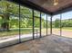 Covered porch with stone floors overlooking the expansive, green backyard of this country home at 2500 Cedar Cove Dr, Harrisburg, NC 28075