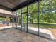 Screened porch featuring stone tile and backyard views at 2500 Cedar Cove Dr, Harrisburg, NC 28075
