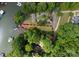 Aerial view of a lakefront home surrounded by lush greenery at 328 Whippoorwill Rd, Mooresville, NC 28117