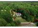 Aerial view of the property surrounded by lush greenery, showcasing its expansive size and privacy at 328 Whippoorwill Rd, Mooresville, NC 28117
