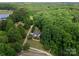A high angle view of a lovely home nestled amidst lush, mature trees and landscaping at 328 Whippoorwill Rd, Mooresville, NC 28117