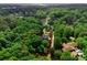 Aerial view of the property surrounded by lush greenery, showcasing its expansive size and privacy at 328 Whippoorwill Rd, Mooresville, NC 28117