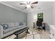 Bedroom featuring soft gray tones, a comfortable sofa, and a dedicated workspace by the window at 328 Whippoorwill Rd, Mooresville, NC 28117