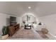 Bonus room features a comfortable seating area, soft lighting, and a textured rug for a cozy ambiance at 328 Whippoorwill Rd, Mooresville, NC 28117