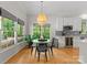 Bright breakfast nook with hardwood floors, modern lighting, and views of the backyard at 328 Whippoorwill Rd, Mooresville, NC 28117