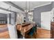 Elegant dining room with hardwood floors, modern lighting fixture, and gray accent walls at 328 Whippoorwill Rd, Mooresville, NC 28117