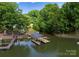 Overhead view of a covered dock on the water, providing a perfect spot for boating and lakeside enjoyment at 328 Whippoorwill Rd, Mooresville, NC 28117
