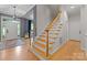 Inviting foyer features hardwood floors, staircase with wood treads, and a view to the home's entrance at 328 Whippoorwill Rd, Mooresville, NC 28117