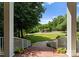 A beautifully landscaped front yard as seen from the brick-paved covered front porch at 328 Whippoorwill Rd, Mooresville, NC 28117