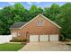 Spacious three-car garage with a basketball hoop and lush greenery at 328 Whippoorwill Rd, Mooresville, NC 28117