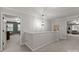 Upstairs hallway leading into various rooms, showcasing a pendant light and architectural details at 328 Whippoorwill Rd, Mooresville, NC 28117