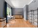 Bright home office with large windows, hardwood floors, custom shelving, and modern furnishings at 328 Whippoorwill Rd, Mooresville, NC 28117