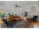 Open living room features hardwood floors, modern furnishings, and seamless access to the kitchen at 328 Whippoorwill Rd, Mooresville, NC 28117