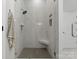 The bright shower area features a rainfall shower head and modern tile, blending luxury and function at 328 Whippoorwill Rd, Mooresville, NC 28117