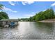 Picturesque waterfront featuring a boat dock, surrounded by lush greenery and offering serene water views at 328 Whippoorwill Rd, Mooresville, NC 28117