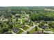 Wide aerial shot of a sprawling residential area with lush greenery and mature trees throughout at 335 Wintergreen Ct, Kings Mountain, NC 28086