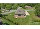 Aerial view of a home with a large yard, screened in porch and three car garage in a neighborhood at 335 Wintergreen Ct, Kings Mountain, NC 28086