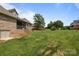 Exterior of home featuring a screened porch and steps down to the backyard with a large grassy area at 335 Wintergreen Ct, Kings Mountain, NC 28086