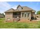 Exterior of home featuring a screened porch and steps down to the backyard at 335 Wintergreen Ct, Kings Mountain, NC 28086