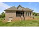 Exterior of home featuring a screened porch and steps down to the backyard and basement access at 335 Wintergreen Ct, Kings Mountain, NC 28086