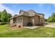 Exterior of home featuring a screened porch, patio area, and a well-maintained lawn at 335 Wintergreen Ct, Kings Mountain, NC 28086