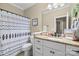 Well-lit bathroom featuring granite countertop vanity and patterned shower curtain at 335 Wintergreen Ct, Kings Mountain, NC 28086