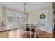 Light-filled dining room features an elegant chandelier and bright natural light from exterior windows at 335 Wintergreen Ct, Kings Mountain, NC 28086