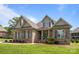 Charming brick and stone two-story home with manicured lawn and inviting front porch at 335 Wintergreen Ct, Kings Mountain, NC 28086