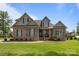 Charming brick and stone two-story home with manicured lawn and inviting front porch at 335 Wintergreen Ct, Kings Mountain, NC 28086