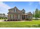 Charming brick and stone two-story home with manicured lawn and inviting front porch at 335 Wintergreen Ct, Kings Mountain, NC 28086