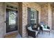 Inviting front porch with a welcoming wreath on the door and comfortable seating area at 335 Wintergreen Ct, Kings Mountain, NC 28086