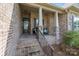 Inviting front porch features brick columns, wrought iron railings, and stylish seating at 335 Wintergreen Ct, Kings Mountain, NC 28086