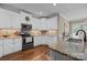 Well-equipped kitchen with white cabinetry, stainless steel appliances, and granite countertops at 335 Wintergreen Ct, Kings Mountain, NC 28086