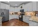 View of the kitchen featuring white cabinets, granite countertops and a full stainless steel appliance package at 335 Wintergreen Ct, Kings Mountain, NC 28086