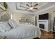 Spacious main bedroom featuring fireplace, hardwood floors, and neutral color palette at 335 Wintergreen Ct, Kings Mountain, NC 28086