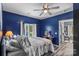 Bright bedroom featuring an attached seating area and a window view with white curtains at 35 Telephone Exchange Rd, Hickory, NC 28601