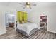 Bright bedroom featuring hardwood floors, neutral walls, and an attached bathroom with a vanity at 35 Telephone Exchange Rd, Hickory, NC 28601