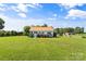 Beautiful residence featuring a well-kept lawn, a new metal roof, and colorful flowers framing the front of the home at 35 Telephone Exchange Rd, Hickory, NC 28601