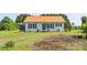 Well-maintained home featuring a green front door, complementary shutters, and attractive, low-maintenance landscaping at 35 Telephone Exchange Rd, Hickory, NC 28601