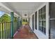 Relaxing covered porch featuring a swing, wood flooring, white columns, and views of the well-manicured yard at 35 Telephone Exchange Rd, Hickory, NC 28601